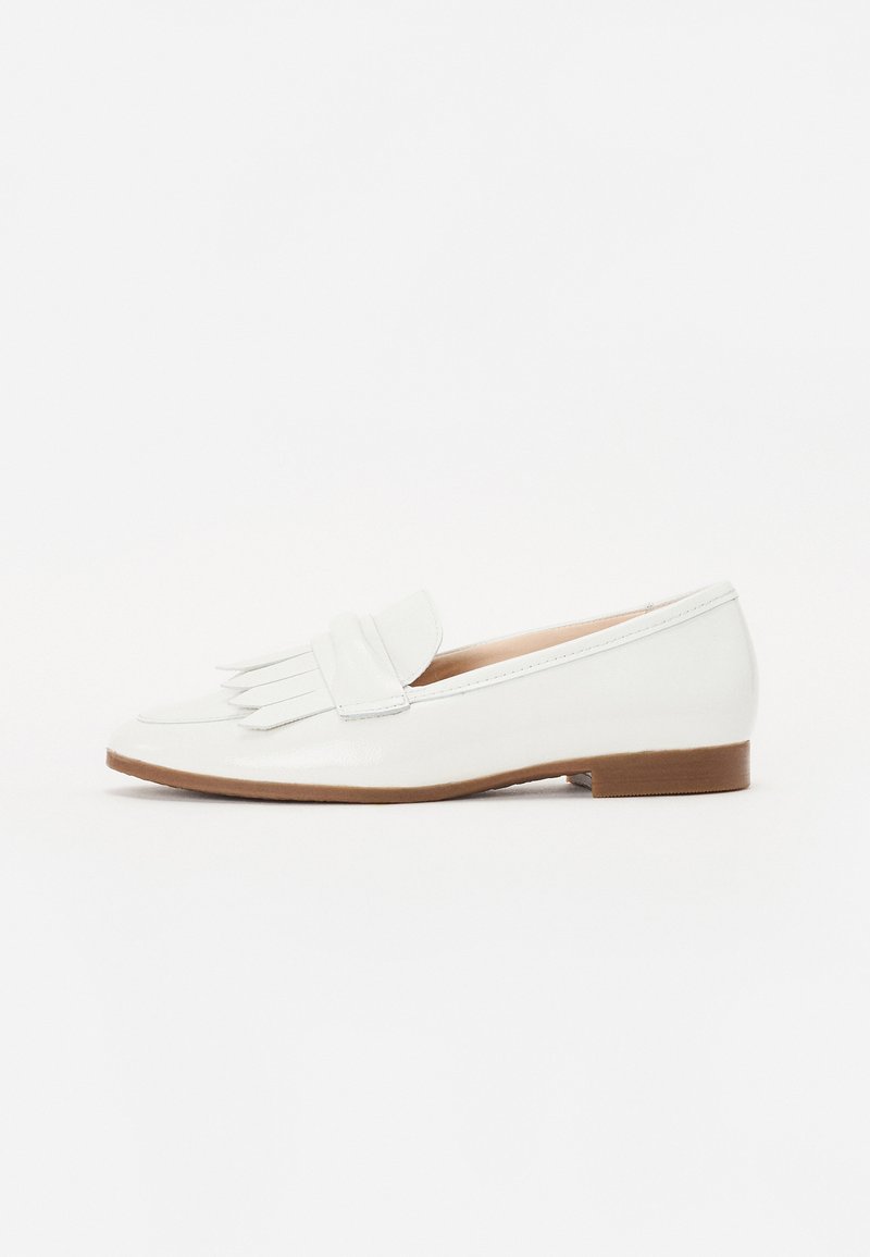 White patent leather loafer with fringe detail on the upper, rounded toe, and a low brown block heel. Smooth texture and minimalist design.