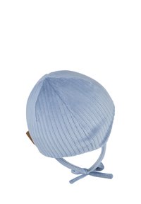 Light blue ribbed knit baby hat with tied chin straps and a small brown tag on the side, isolated on white background.