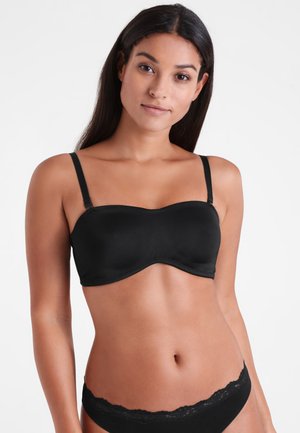 Zwarte strapless beha gemaakt van glad materiaal met een gevormde cupdesign. Verstelbare bandjes en naadloze randen voor een strakke afwerking.