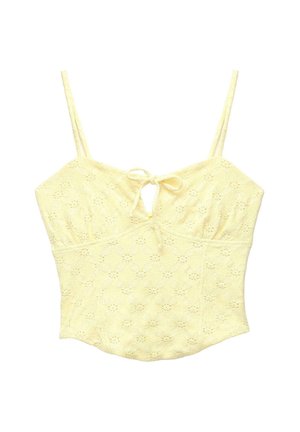 Top court en dentelle jaune avec de fines bretelles et un petit nœud noué au niveau du col, arborant un léger motif floral.