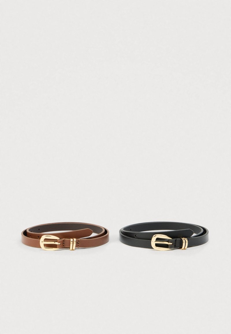 Two rolled leather belts side by side, one brown and one black, both with gold metal buckles and loops on a plain light background.