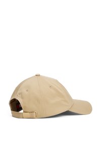 Casquette en coton beige avec une visière incurvée, sangle ajustable à l'arrière et trous de ventilation sur les côtés. Design minimaliste avec une texture lisse.