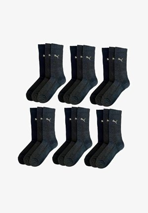 Four pairs of ribbed socks in dark grey and navy blue, featuring a small white logo on each sock, made from a soft, textured material.
