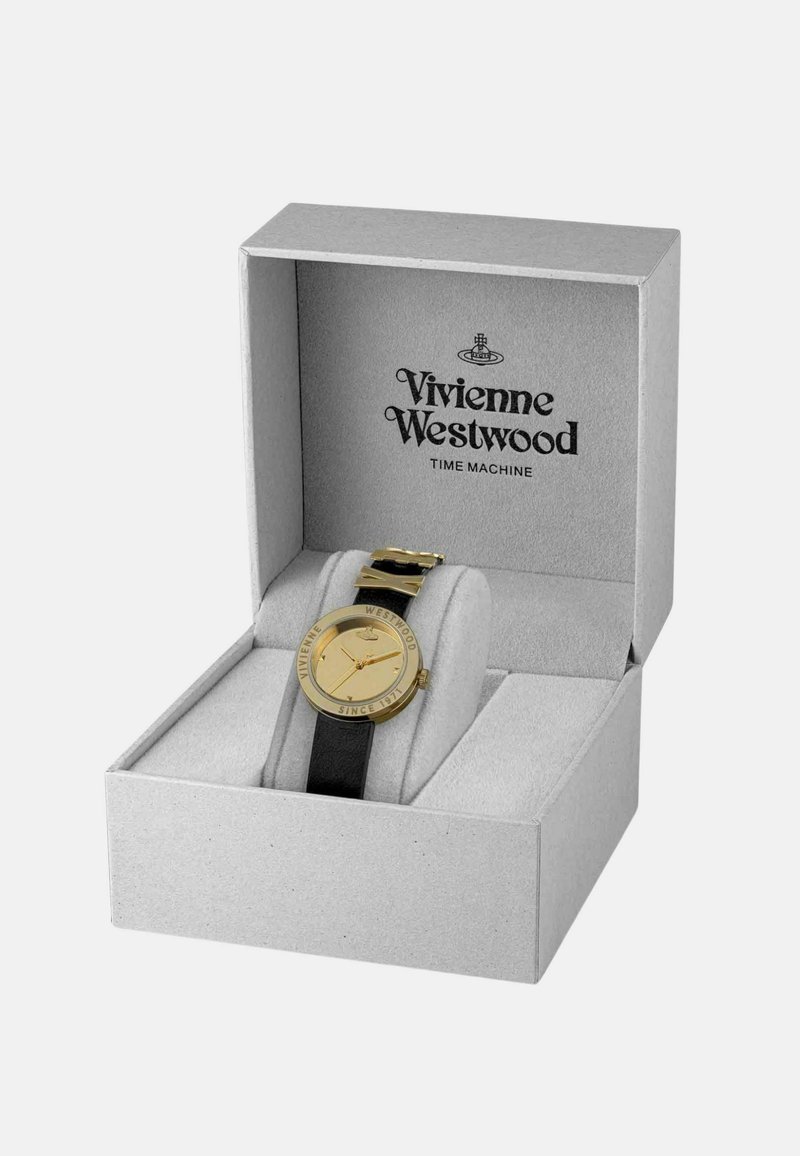 Gold watch with a circular face and black leather strap, presented in a gray box with "Vivienne Westwood TIME MACHINE" logo.