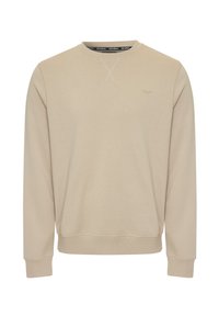 Sudadera de cuello redondo beige con mangas largas. Tejido suave, puños y dobladillo acanalados, logo sutil en el pecho y detalle de costura central en el escote.