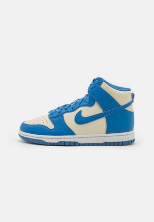 Sneaker alta Nike con un design in pelle blu e crema, chiusura con lacci, punta perforata e suola blu testurizzata con spettinature.