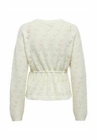 Pull tricoté crème à manches longues, motif à mailles ouvertes, taille élastique, et poignets et ourlet côtelés. Surface texturée avec motifs en losange.