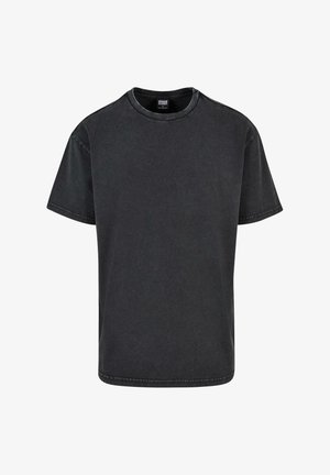 T-shirt in cotone nero con collo rotondo, maniche corte e vestibilità rilassata. Presenta cuciture visibili e una texture leggermente sbiadita.