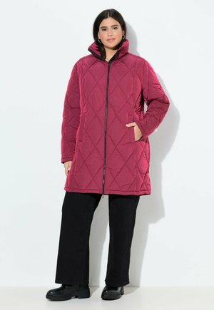 Maroon quilted long coat with high collar, zip front closure, and side pockets, paired with black wide-leg pants and black boots.