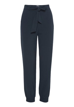 Námornícky modré tapered nohavice z jemnej látky, ktoré majú opasok so šnúrkou a elastické manžety pre nastaviteľný strih. Hladká textúra bez vzorov.