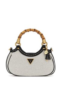 Small white and black Guess handbag with bamboo handle, gold hardware, and logo charm on front.