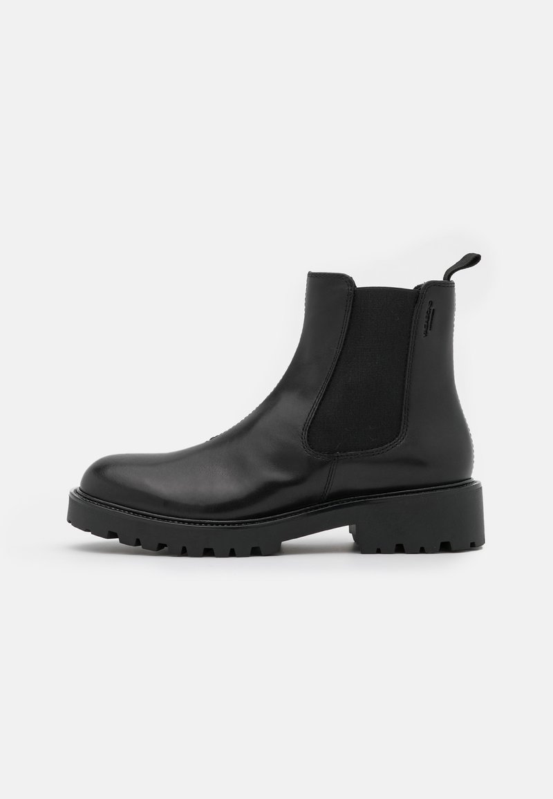 Black leather ankle boot with elastic side panels, rugged sole, and pull tab. Features a sleek design with a rounded toe and a low heel.