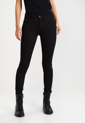 Jeans skinny negros fabricados con denim elástico de textura suave. Incluyen una cintura de altura media, cierre de botón y cinco bolsillos.
