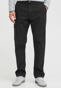 Black cargo pants with a straight fit, made of durable fabric, featuring side pockets, a button closure, and belt loops.