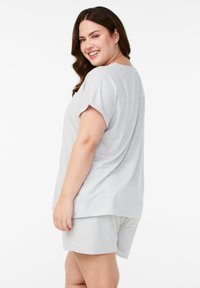 Gray short-sleeve top and matching shorts in a soft, ribbed material with a relaxed fit and subtle stripes.