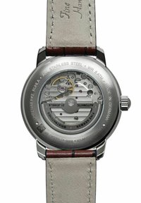 Automatische Edelstahl-Uhr mit komplizierter mechanischer Bewegung, transparentem Gehäuseboden und grauem Lederarmband mit braunen Akzenten.
