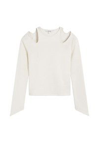 Haut à manches longues de couleur crème avec des découpes aux épaules, ourlet droit et tissu texturé. Design simple sans motifs ni accessoires visibles.