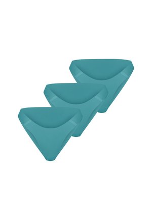 Drie naadloze damesonderbroeken in teal gekleurd, diagonaal gestapeld op een witte achtergrond.