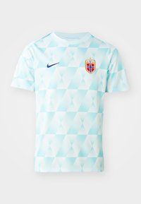 Heledad siniste värvi lühikeste varrukatega jalgpallipaita, millel on teemantmuster, kuldsete aktsentidega Norra emblem ja sinine Nike logo.