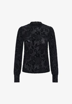 Blouse noire à manches longues avec motif floral en velours, col montant, tissu texturé et poignets resserrés.