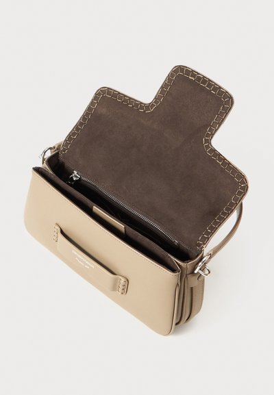 Beige leather bag with a brown suede interior. Features a structured shape, zip compartment, and decorative stitching along the opening.