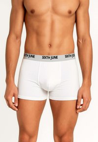 Male torso wearing white boxer briefs with gray waistband labeled "SIXTH JUNE" on a plain light background.
