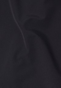 Black fabric showing a soft, smooth texture with subtle draping. The surface is uniform, without any patterns or visible seams.