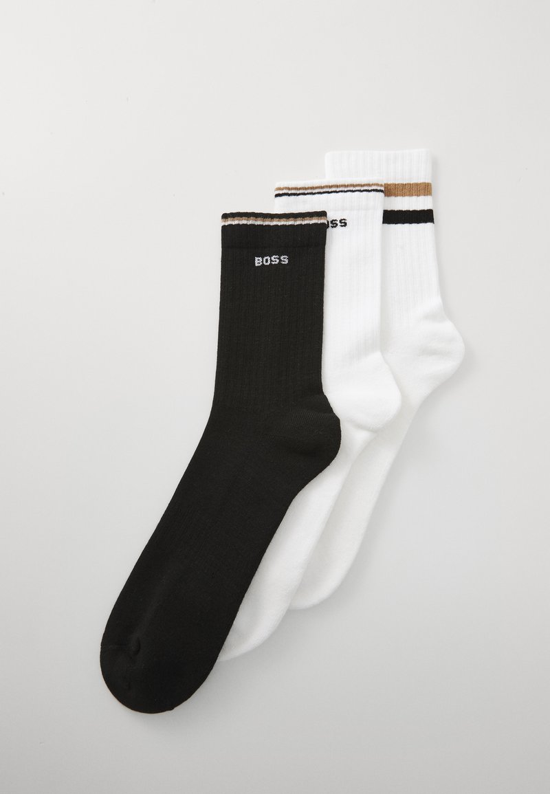 Three pairs of ribbed crew socks in black and white, each with "BOSS" text and contrasting stripes near the cuff.