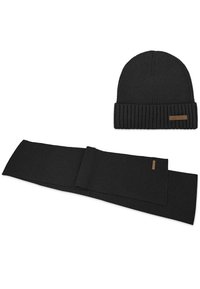 Schwarze gestrickte Beanie-Mütze mit Rippstruktur und umgeschlagenem Saum, kombiniert mit einem passenden schwarzen Schal, beide mit einem kleinen braunen Logo-Tag.
