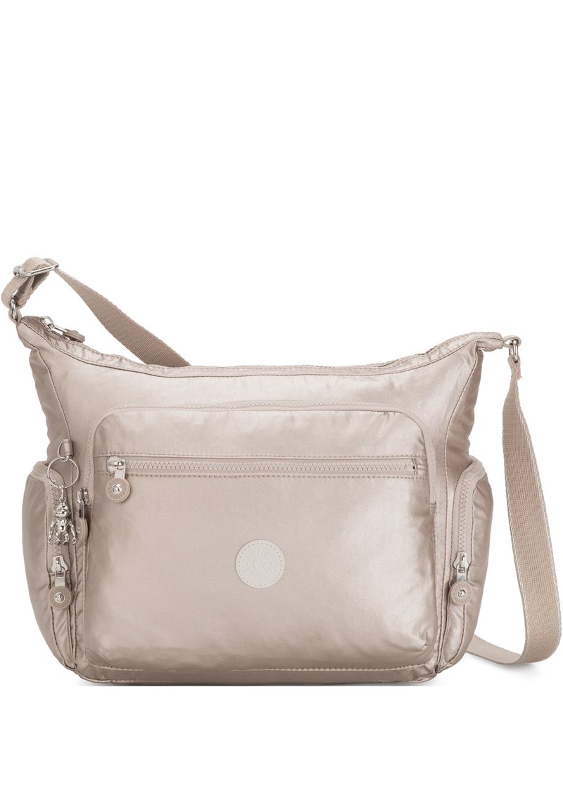 Beige nylon crossbody bag with adjustable strap, front zip pocket, and circular logo patch. Smooth texture and shiny finish.