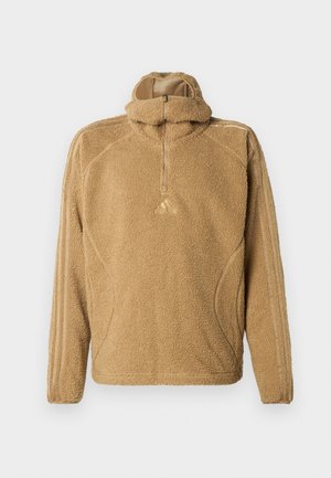 Pullover de fleece em castanho claro, com gola de fecho de meia, mangas longas e tecido texturizado com riscas laterais tonais.