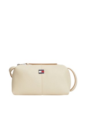 Portamonete in pelle testurizzata color crema con cerniera e piccolo logo Tommy Jeans sul davanti, con cinturino per polso sul lato.