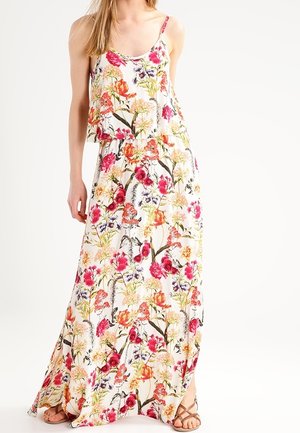 Květinové maxi šaty s tenkými ramínky, mají bílý základ a živé růžové, oranžové a fialové botanické potisky po celém vzoru.