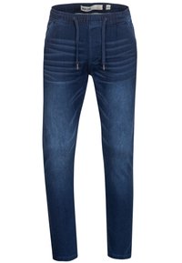 Dark blue denim jogger pants with an elastic waistband, drawstring, and side ribbed accents for texture. Tapered fit with cuffed ankles.