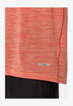Červená a oranžová melírovaná sportovní košile s krátkými rukávy, s prošitým spodním lemem a malou nášivkou ACTIBREEZE na dolní straně.