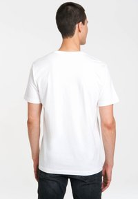 White cotton t-shirt with a crew neckline and short sleeves, featuring a standard fit. The back is plain with no visible patterns or logos.
