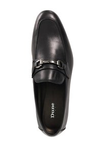 Black leather slip-on shoe with a pointed toe, featuring a decorative silver buckle across the vamp. Smooth texture and elegant design.