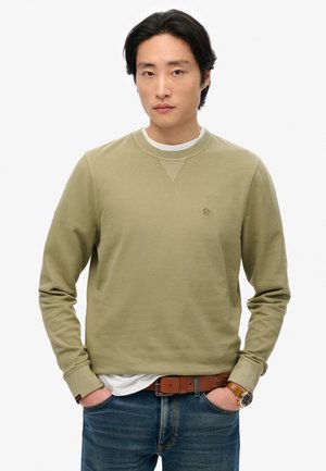 Olive green sweatshirt with a round neck, ribbed cuffs, and a subtle logo on the chest, paired with light blue denim jeans and a brown belt.