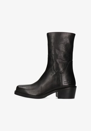 Black leather ankle boot with a rounded toe, smooth texture, short block heel, and minimal branding on the side.