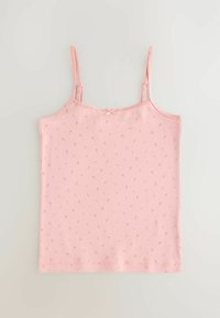 Pink cotton camisole with thin straps, featuring a delicate floral print and a small bow detail at the neckline. Soft, lightweight fabric.
