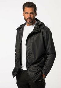 Black lightweight jacket with a hood and zippered front, featuring a smooth, shiny texture. Worn over a white T-shirt and black pants.
