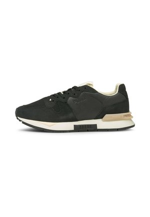 Czarno-beżowy sneaker Puma z siateczkową i skórzaną cholewką, zawiązywany na sznurowadła, z teksturowaną gumową podeszwą.