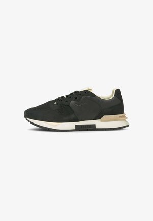 Czarno-beżowy sneaker Puma z siateczkową i skórzaną cholewką, zawiązywany na sznurowadła, z teksturowaną gumową podeszwą.