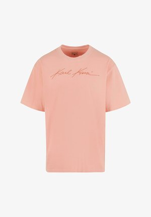 Rosa Baumwoll-T-Shirt mit lockerer Passform, kurzen Ärmeln und rundem Ausschnitt, mit einem charakteristischen Logo in einem kontrastierenden Farbton.