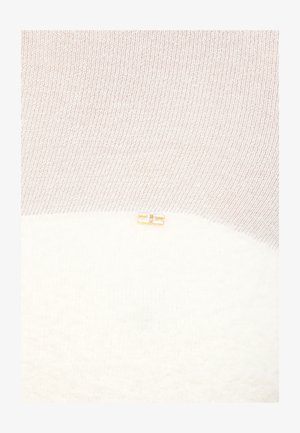 Tessuto lavorato a maglia color crema e beige con un piccolo ornamento rettangolare in oro e strass posizionato al centro vicino alla cucitura.