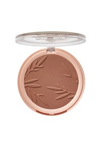 Bronzer compact dans un étui rond et transparent. Poudre marron clair avec un motif de feuille. Texture lisse et teinte chaude et neutre.