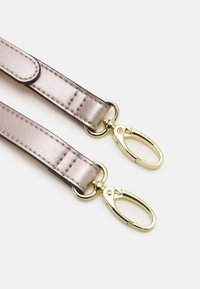 Metaliczny różowo-złoty pasek o gładkiej teksturze, z pozłacanymi klipsami na każdym końcu do mocowania.