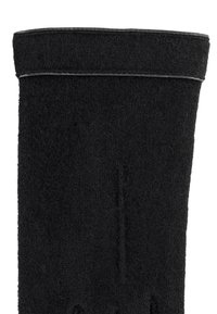 Support de poignet en tissu noir avec fermeture à sangle Velcro, conçu pour un ajustement de compression et de stabilité.