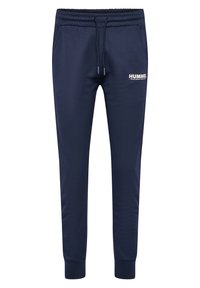 Tummat siniset collegehousut, joissa on joustava vyötärö ja nauhakuja, vasemmalla puolella pieni valkoinen "HUMMEL"-logo ja kapenevat lahkeet.