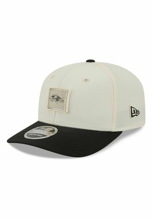 White and black baseball cap with Baltimore Ravens logo patch on front and New Era logo on side.